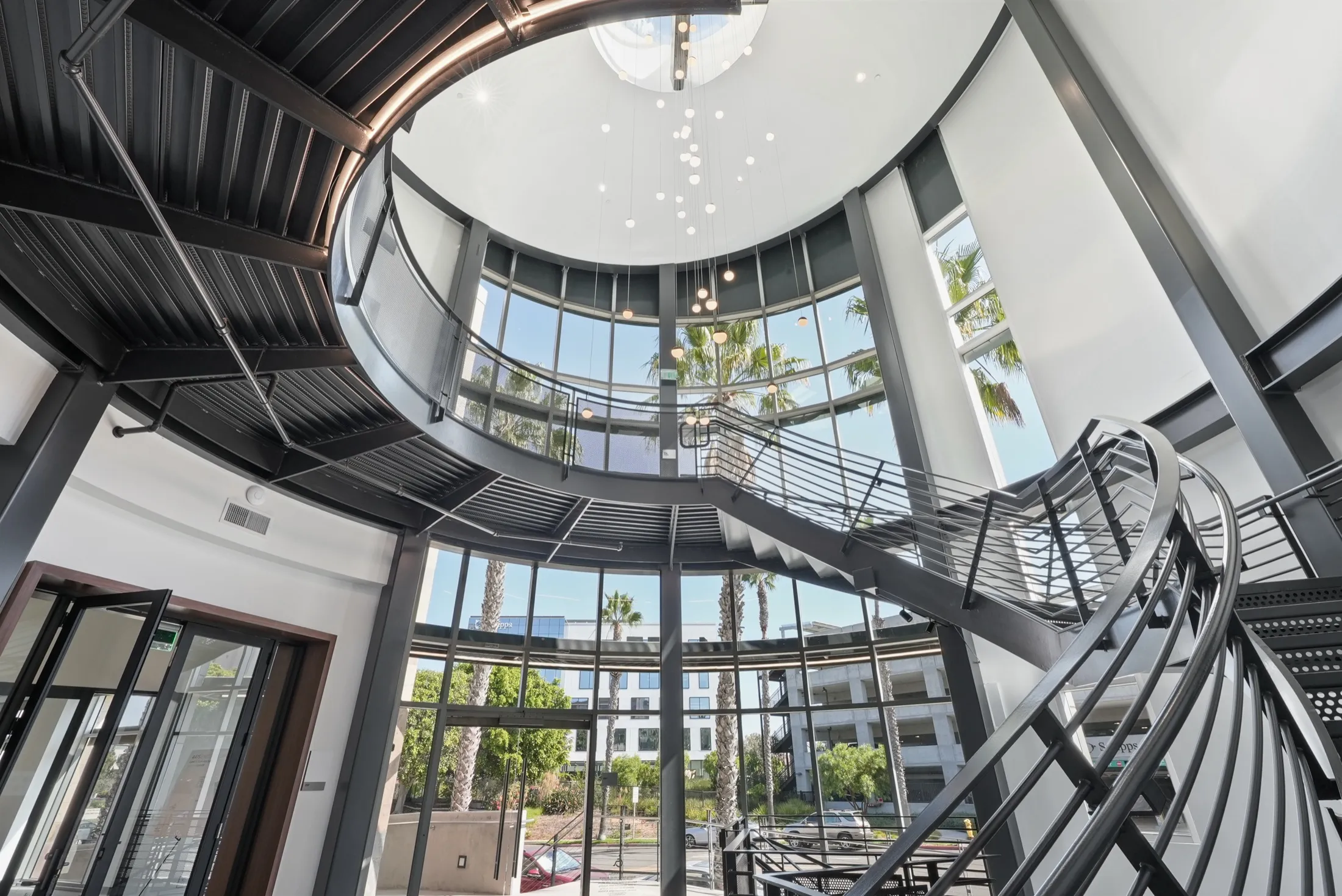 Stair tower and glass lobby at 4475 Executive Drive, San Diego, looking out to the palms
