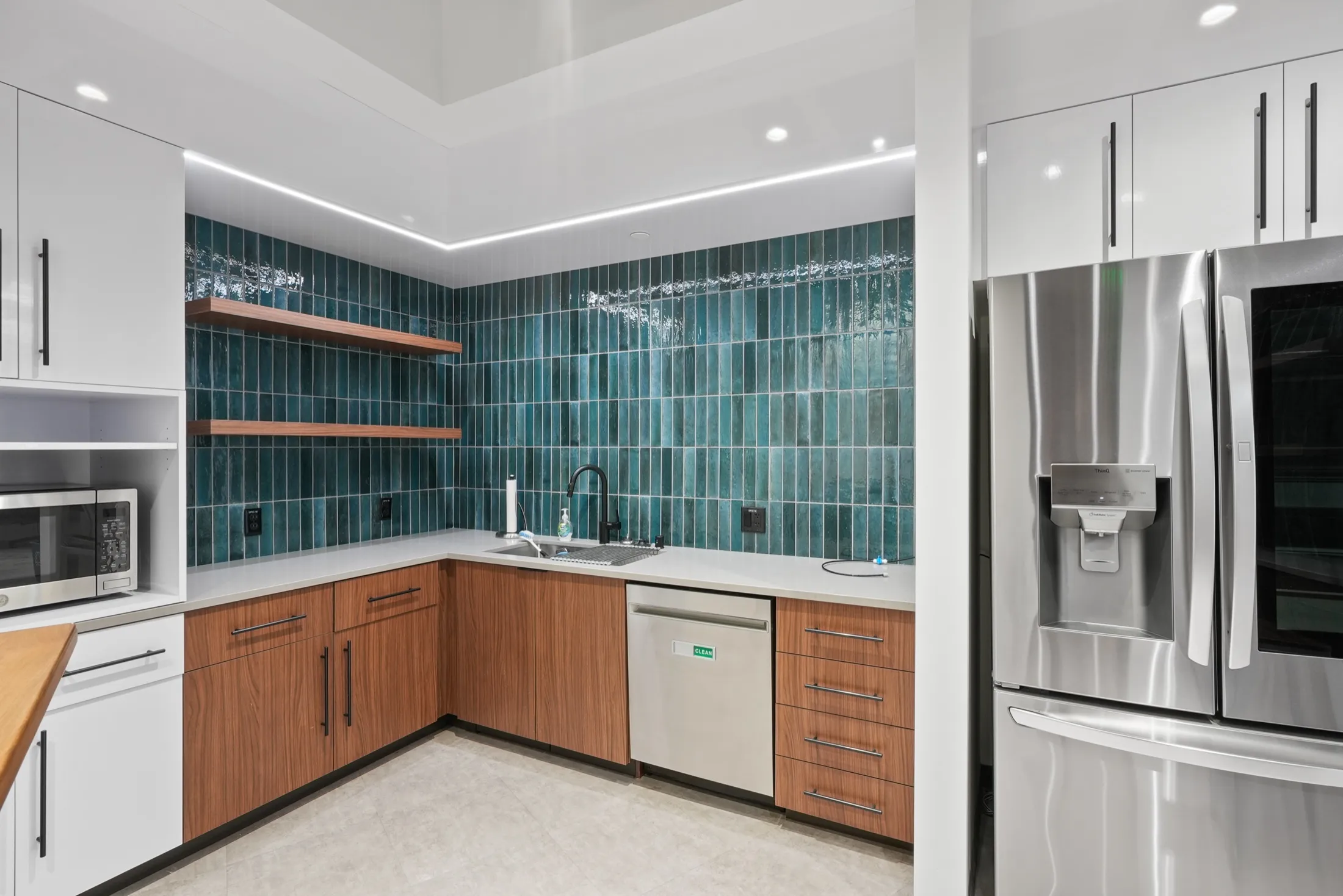 Break room in Suite 150 at 4475 Executive Drive, San Diego, with green tile and walnut cabinets
