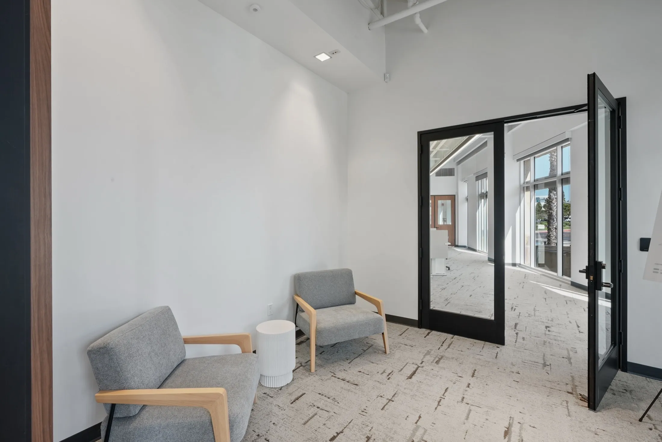 Seating nook by the glass entry doors of Suite 150 at 4475 Executive Drive, San Diego