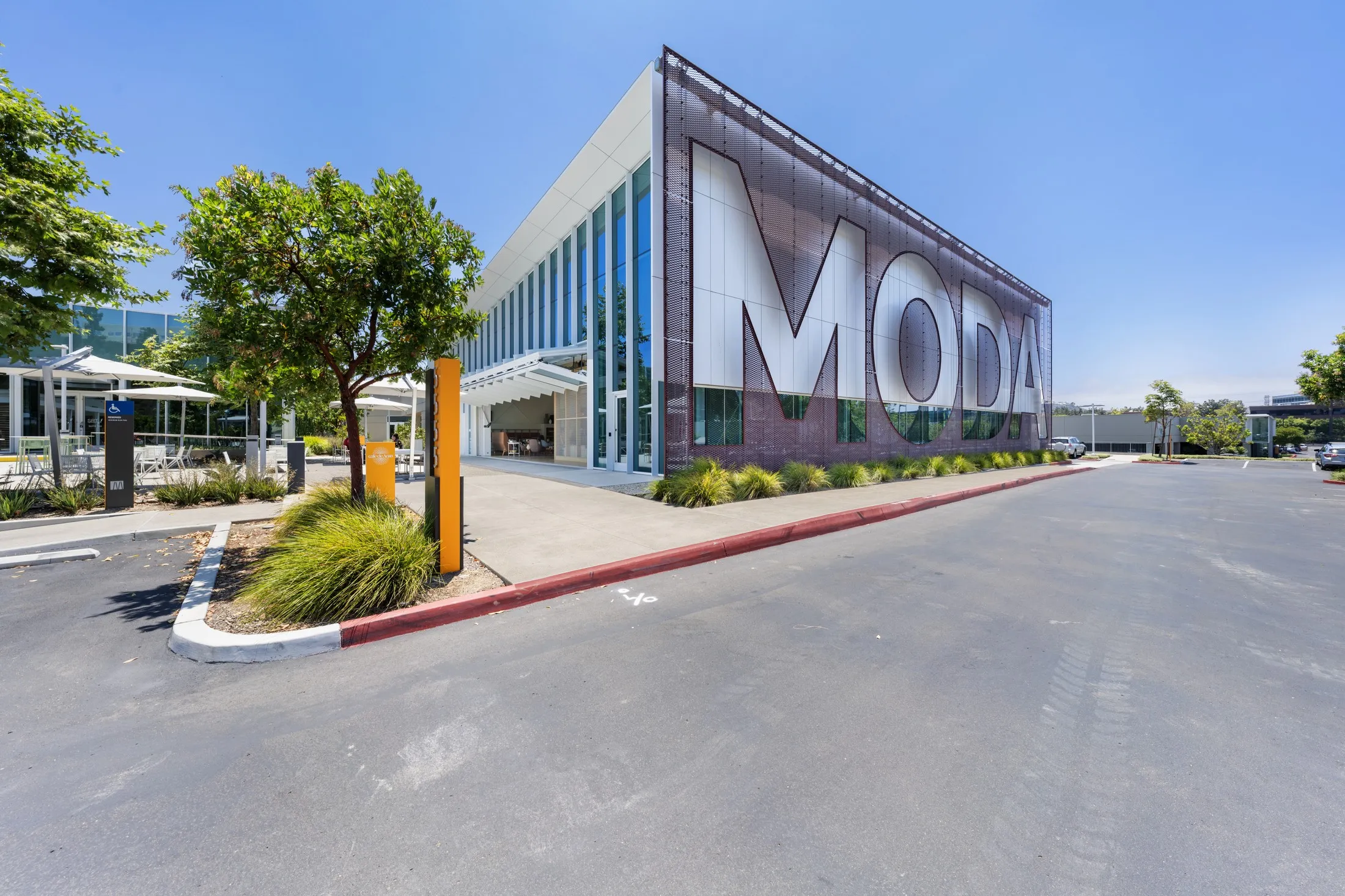 Wide angle of the building corner carrying the large MODA wall graphic
